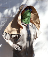 Woman wearing a beige Sun Safe hat that covers face and shoulders, sun safe gloves, sun safe neck scarf covering lower face and sunglasses on.